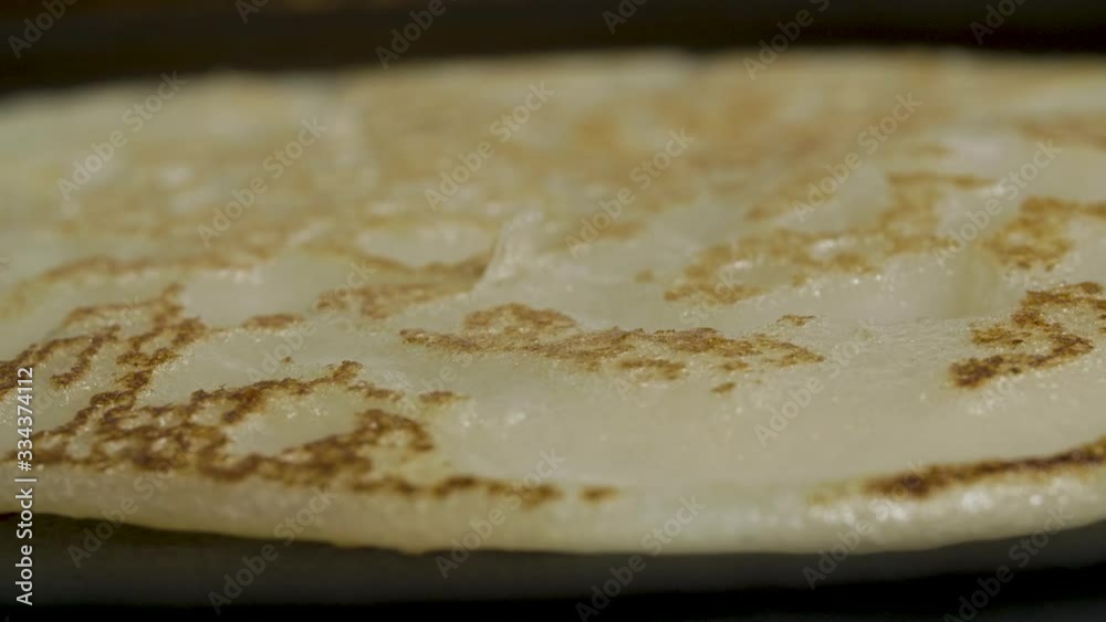 Making fried pancakes in cast iron frying pan top view Making fried pancakes in cast iron frying pan top view