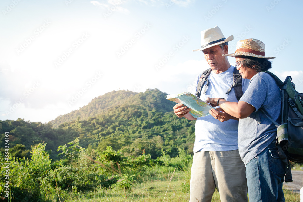 Senior Asian Couple Trekking, traveling, living a happy life in retirement Healthy, can see the fresh nature. The concept of health tourism for the elderly. with copy space. Senior Asian Couple Trekking, traveling, living a happy life in retirement Healthy, can see the fresh nature. The concept of health tourism for the elderly. with copy space.