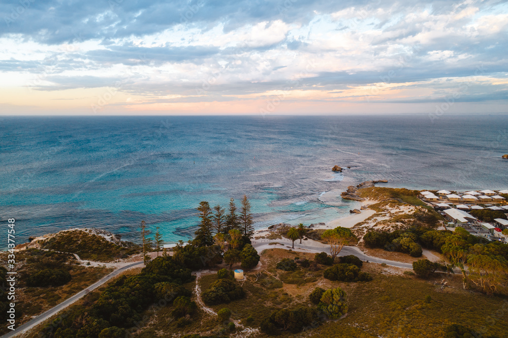 Aerial drone shot of Rottnest Island at sunrise. The Basin and Pinky beach can be seen below. 
