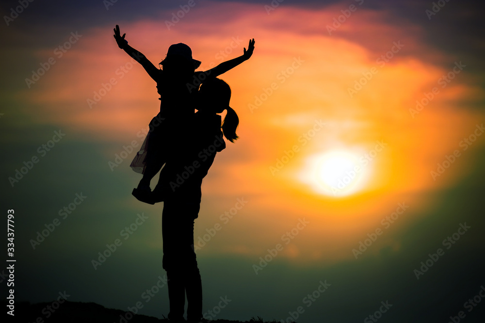 silhouette of a family with a happy mother playing with a girl in the sunset sky silhouette of a family with a happy mother playing with a girl in the sunset sky