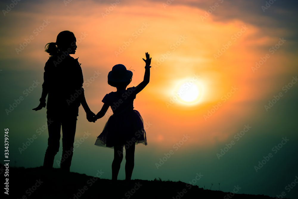 silhouette of a family with a happy mother playing with a girl in the sunset sky silhouette of a family with a happy mother playing with a girl in the sunset sky
