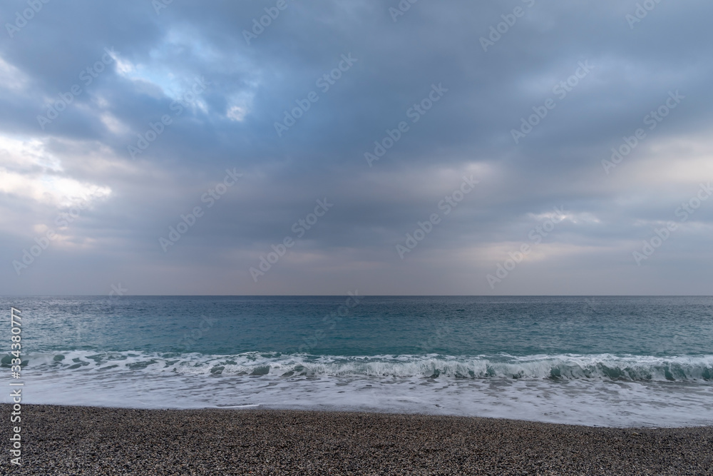 Clouds over the sea in soft sunlight in wintertime, Varigotti, Liguria, Italy