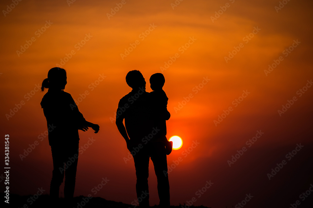 Happy family, father, mother, son in nature, sunset