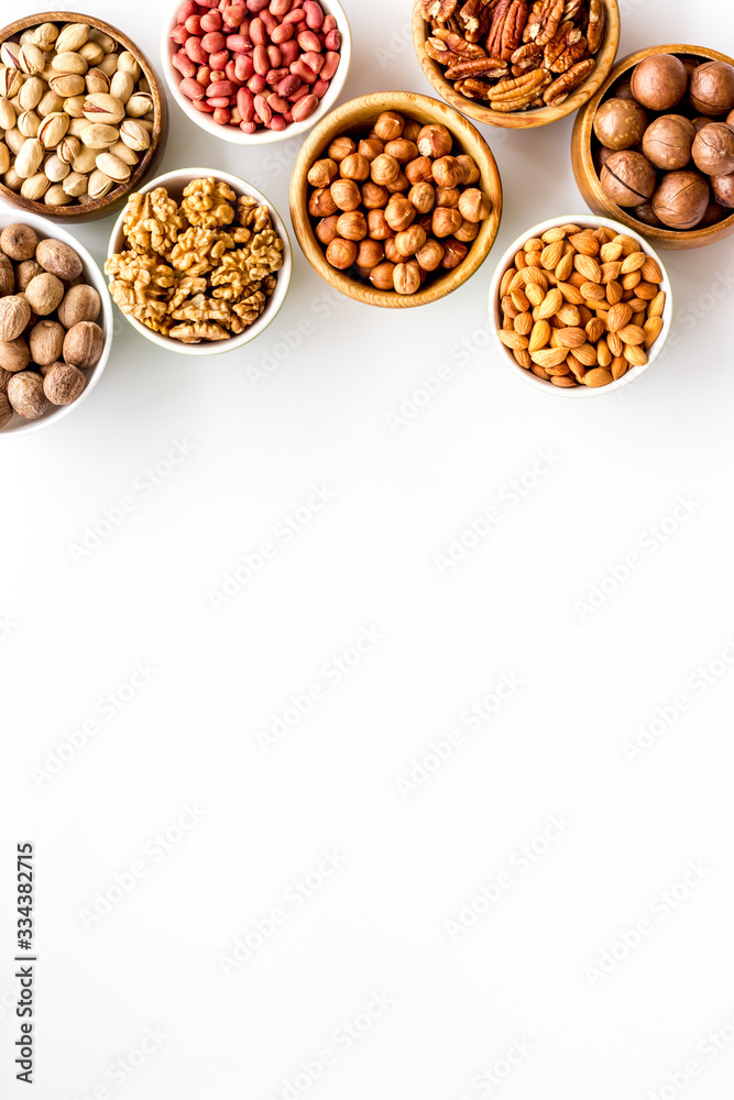 Set of macadamia, hazelnut, walnut, almond, pistachio, pecans nuts on white background top-down frame copy space