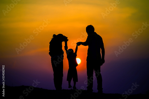 Happy family, father, mother, son in nature, sunset