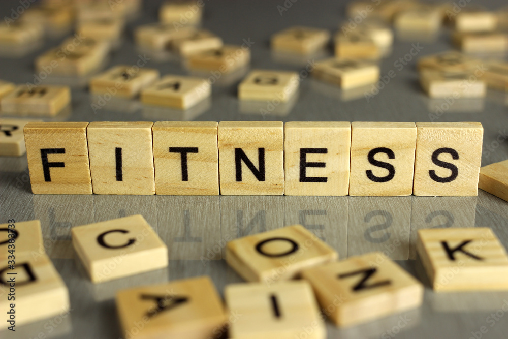 word fitness is made of square wooden letters on a gray background word fitness is made of square wooden letters on a gray background