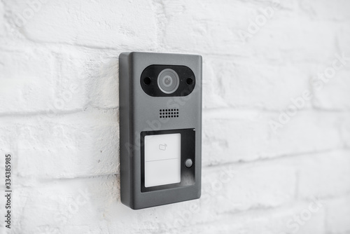 House intercom with a camera on the brick wall outdooors