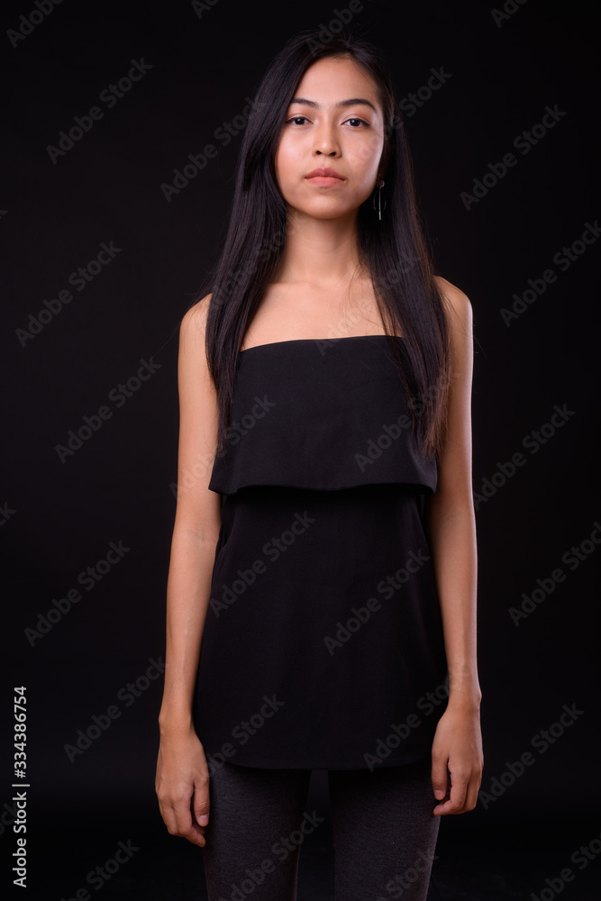 Portrait of young beautiful Asian woman looking at camera Portrait of young beautiful Asian woman looking at camera