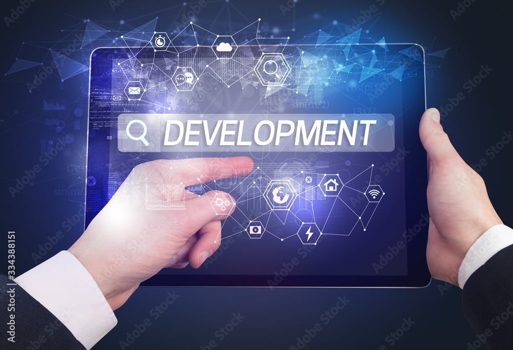 Close-up of a tablet searching DEVELOPMENT inscription, hi-tech computing concept Close-up of a tablet searching DEVELOPMENT inscription, hi-tech computing concept