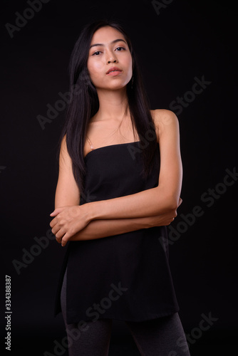 Portrait of young beautiful Asian woman with arms crossed © Ranta Images
