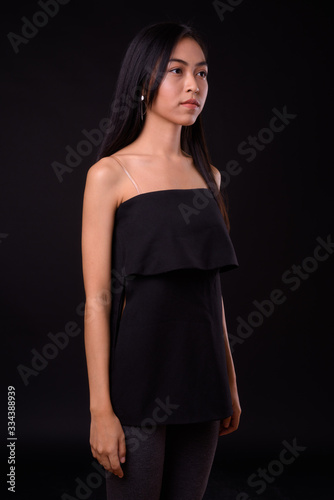 Portrait of young beautiful Asian woman looking away