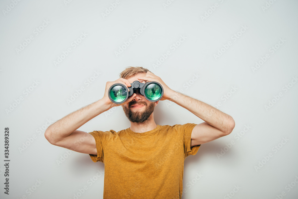 man with binoculars. gray background man with binoculars. gray background