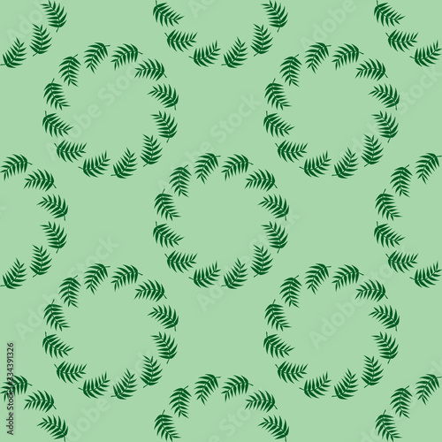 Seamless pattern with fascinating green branches on light green background.  Vector image.