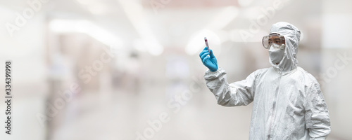 COVID-19, Coronavirus or Novel corona virus epidemic disease with doctor or lab technician scientist in PPE Personal Protective Equipment holding blood tube test in hospital laboratory