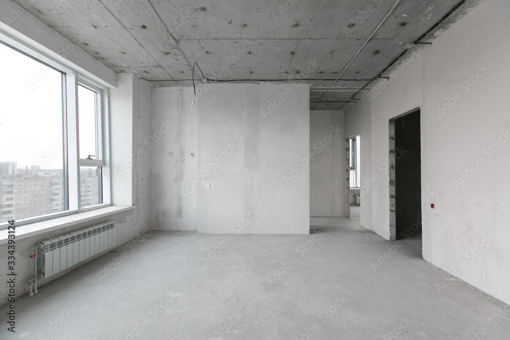 interior of a new apartment without finishing in gray tones with electrical wiring interior of a new apartment without finishing in gray tones with electrical wiring