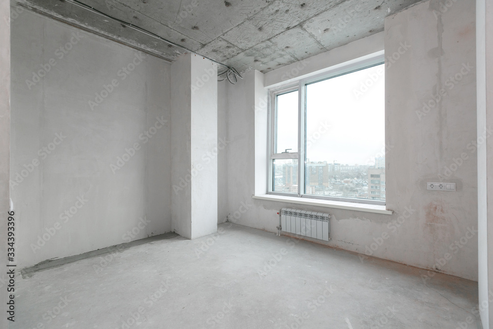 Fototapeta premium interior of a new apartment without finishing in gray tones with electrical wiring