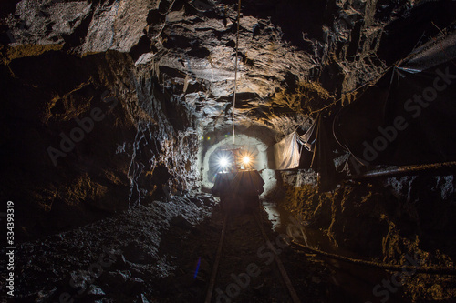 Electric locomotive in underground gold mine tunnel