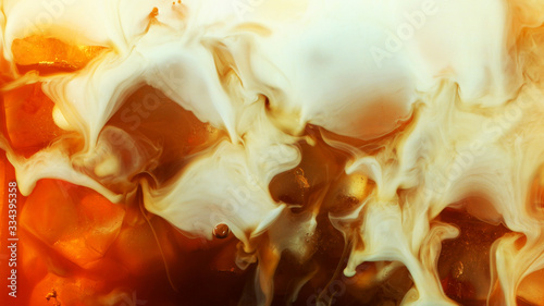 Detail of milk mixing in ice coffee drink