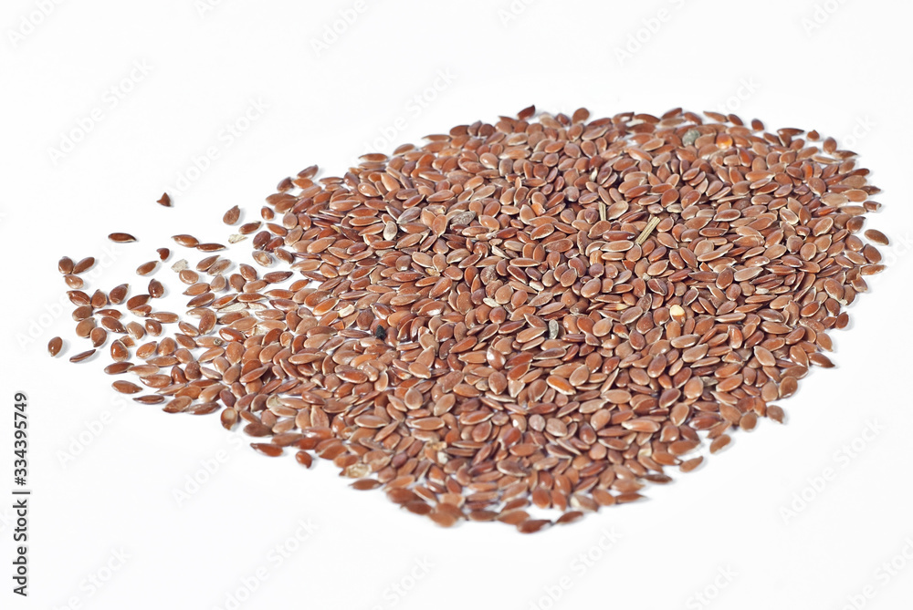 Texture of flax seeds. Many grains of flax on the pile. Flax on a white background. Texture of flax seeds. Many grains of flax on the pile. Flax on a white background.