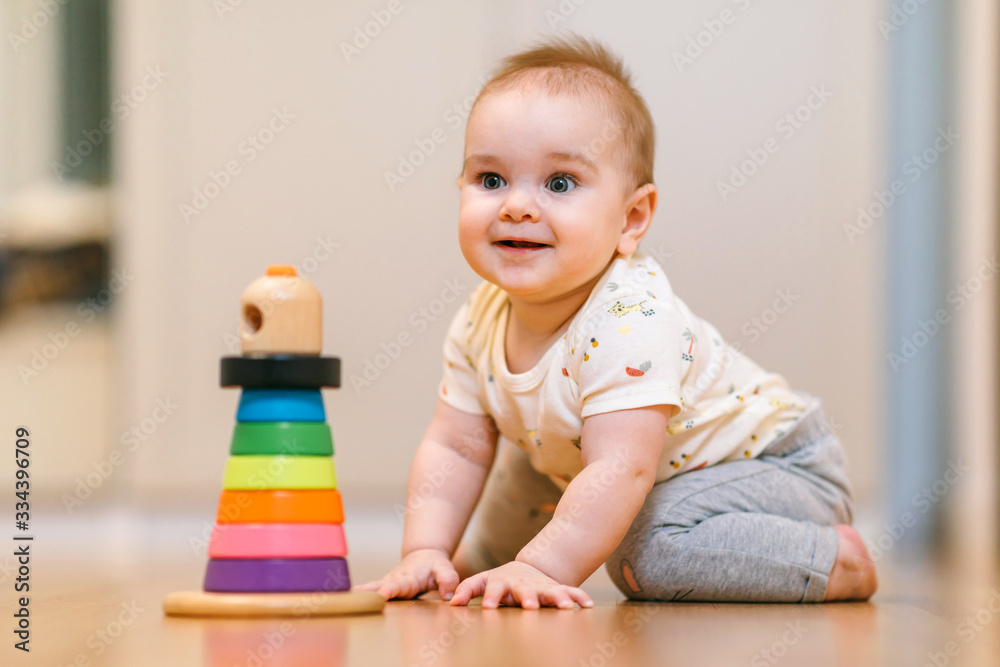 A nine-month-old baby crawls on the floor A nine-month-old baby crawls on the floor