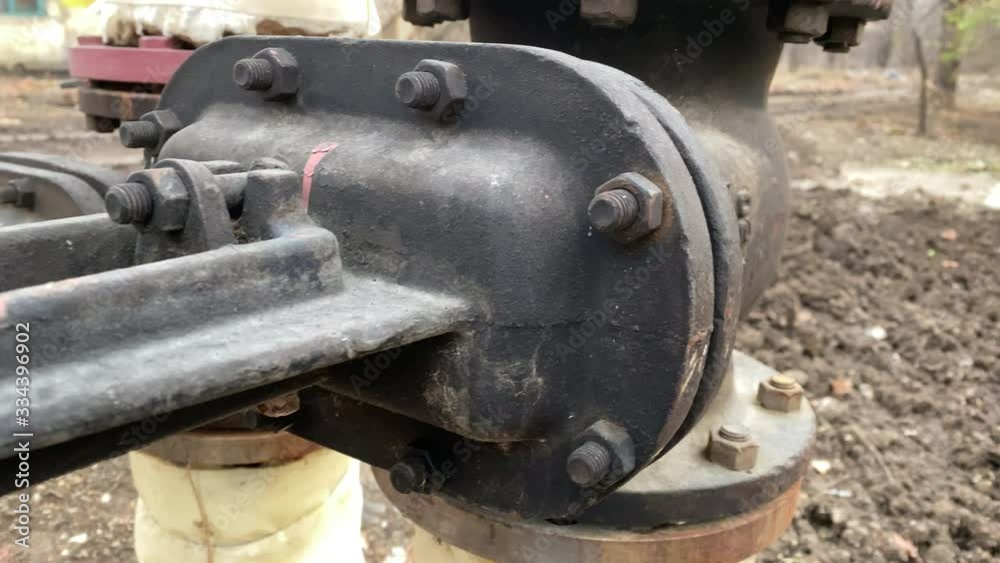 Metal water pipe with large valve installed outside. Metal water pipe with large valve installed outside.