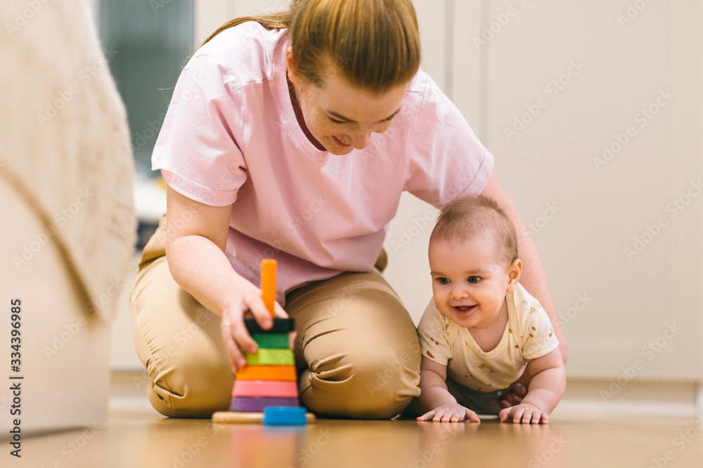 Baby plays with mom. Early development, first games and toys for a baby up to a year Baby plays with mom. Early development, first games and toys for a baby up to a year