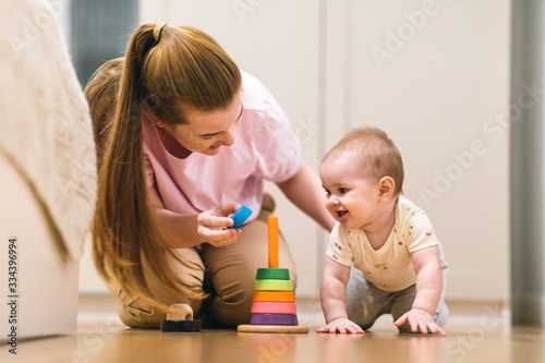 Baby plays with mom. Early development, first games and toys for a baby up to a year