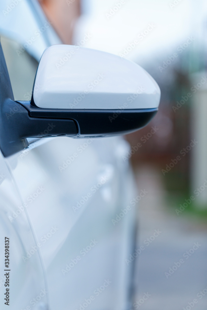 Close up of a wing mirror of white car Close up of a wing mirror of white car