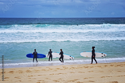 Beginner surfers on the beach. Surfing lesson. Love surfing. Surf school. photo