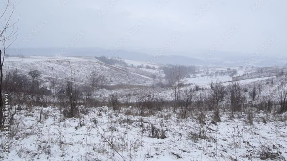Late winter snow falls to the ground. Snow-covered fields Late winter snow falls to the ground. Snow-covered fields