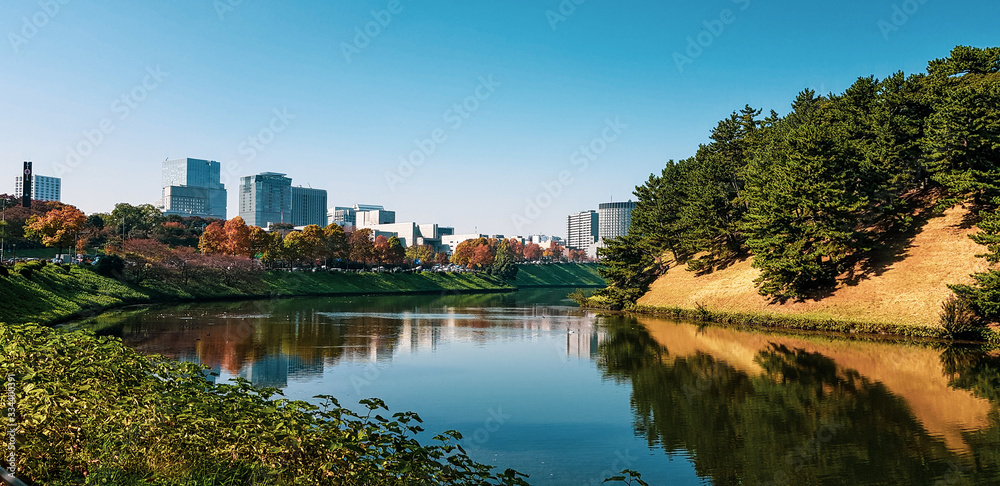 Moat around Imperial Palace, Tokyo, Japan, with city in distance, Autumn colours, beautiful day Moat around Imperial Palace, Tokyo, Japan, with city in distance, Autumn colours, beautiful day
