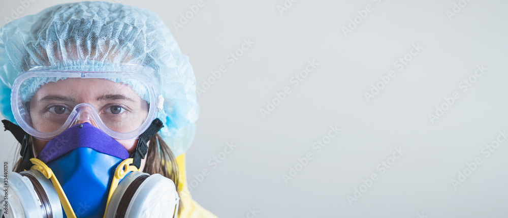 Portrait of a healthcare worker woman in protective glasses and respirator mask. Medical staff, hospital doctor or scientist developing anti virus vaccine portrait with copy space Portrait of a healthcare worker woman in protective glasses and respirator mask. Medical staff, hospital doctor or scientist developing anti virus vaccine portrait with copy space