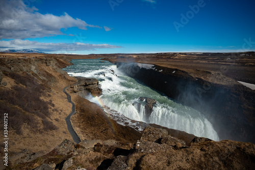 Large Icelandic waterfall on a sunny day with a blue sky