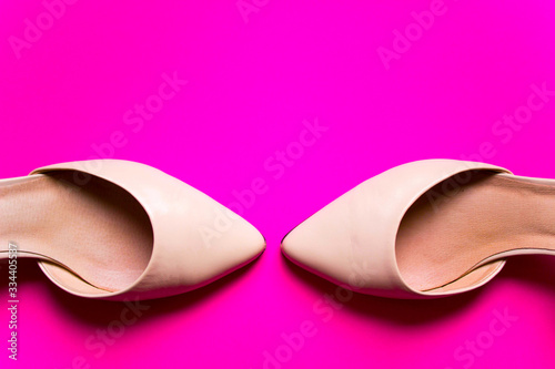 Pair of Pointy shoes on colorful pink background. free copy space. Overhead shot of summer elegant shoes. Top view, flat lay