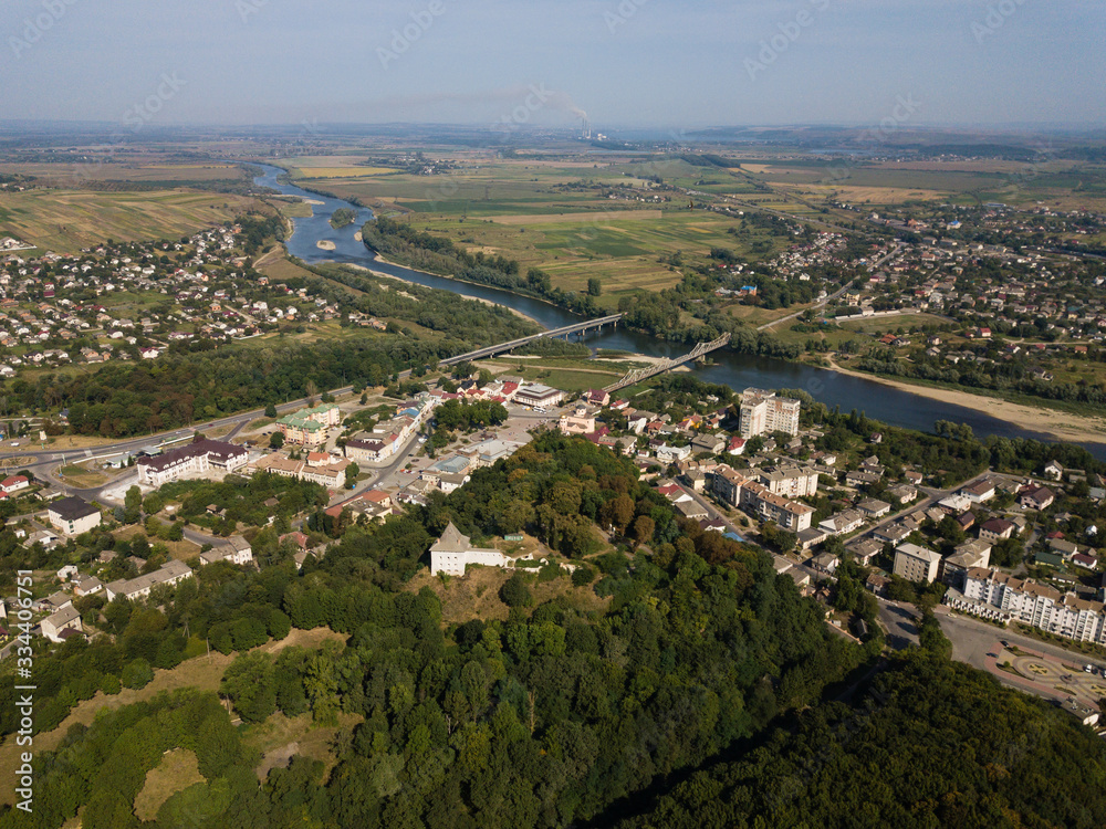 Aerial view of city Halych with ruined castle on hill, river and horisont