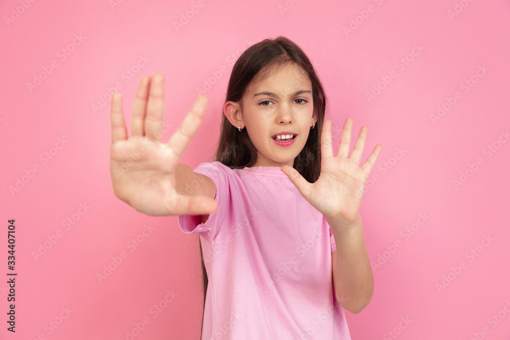 Stop, scared. Caucasian little girl portrait isolated on pink studio background. Cute brunette model in shirt. Concept of human emotions, facial expression, sales, ad, childhood. Copyspace. Stop, scared. Caucasian little girl portrait isolated on pink studio background. Cute brunette model in shirt. Concept of human emotions, facial expression, sales, ad, childhood. Copyspace.