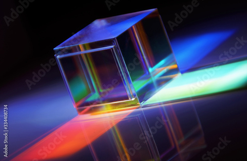 colored beams from a crystal cube photographed on the diagonal