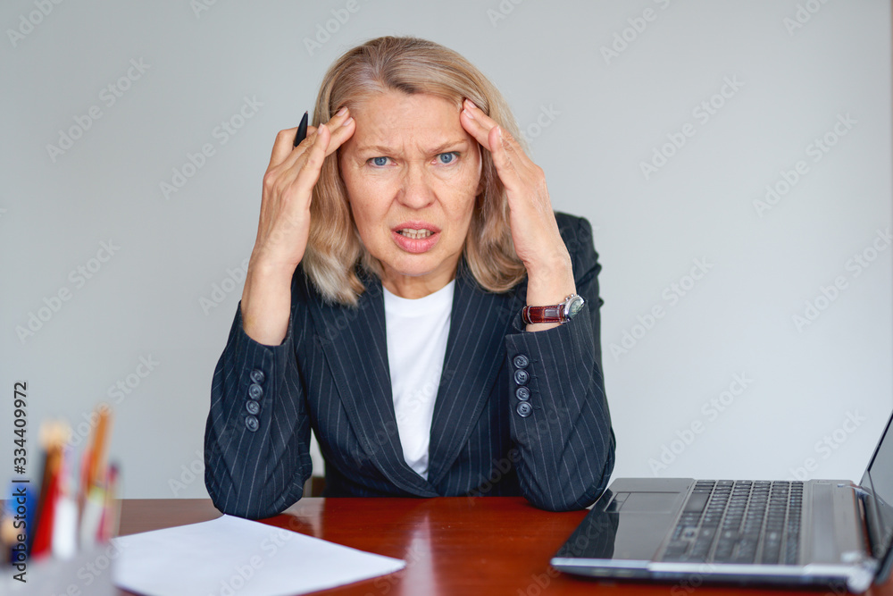 Portrait of a stressed business woman at office. Portrait of a stressed business woman at office.