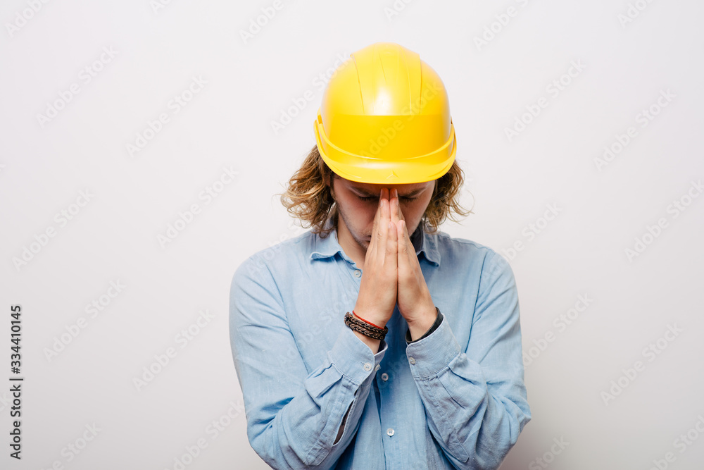 Construction worker praying
