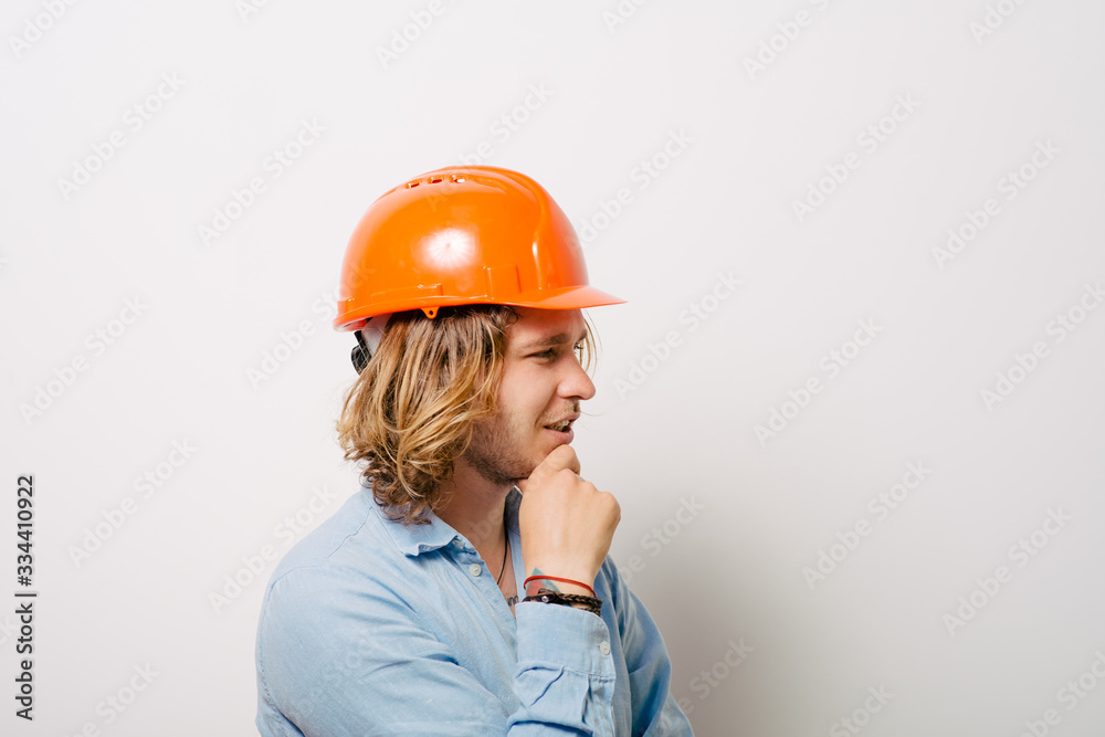 Working man thinking on a gray background Working man thinking on a gray background