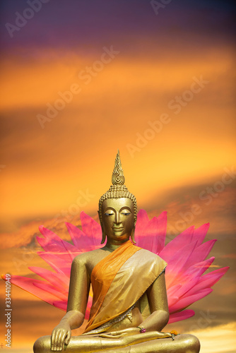 A peaceful superimposed or double exposure images of Golden Buddha statue with a nice background from Ayuthaya, Thailand and a pink lotus. Buddha statue is posing “The attitude of subduing Mara". © athichoke.pim