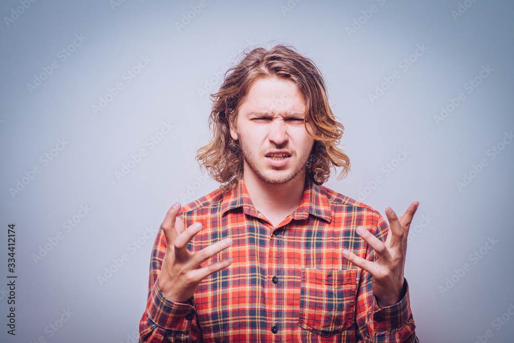 portrait of pissed off young adult man, hands in air portrait of pissed off young adult man, hands in air