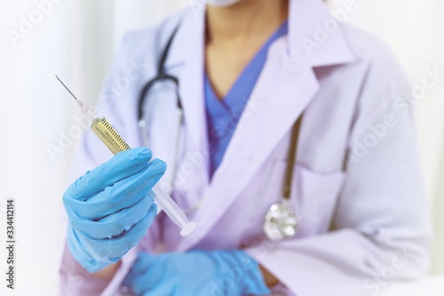 Hand holding syringe and vaccine treatment from Coronavirus covid-19 infection.