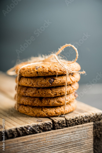 Fresh and healthy cookies with chocolate and seeds on the rustic background. Selective focus. Shallow depth of field.