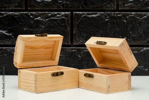 Wooden box with lid on a black background