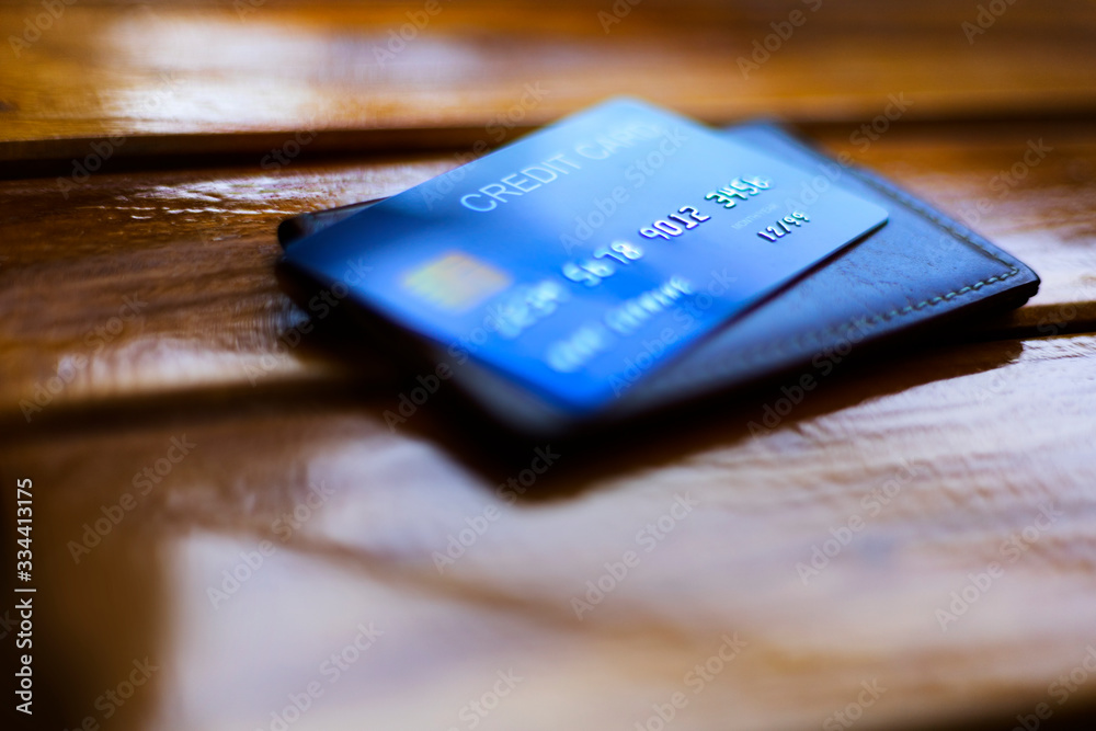 Wallet and credit card on wooden background Wallet and credit card on wooden background