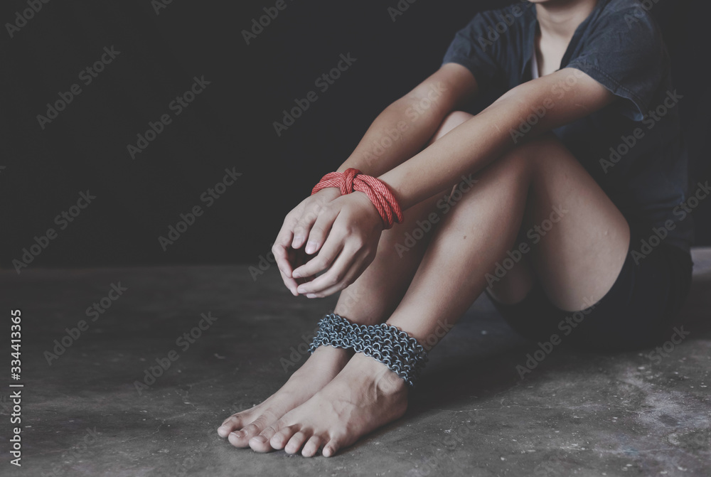 Human trafficking concept. young girl with chain tied.Abused and ...