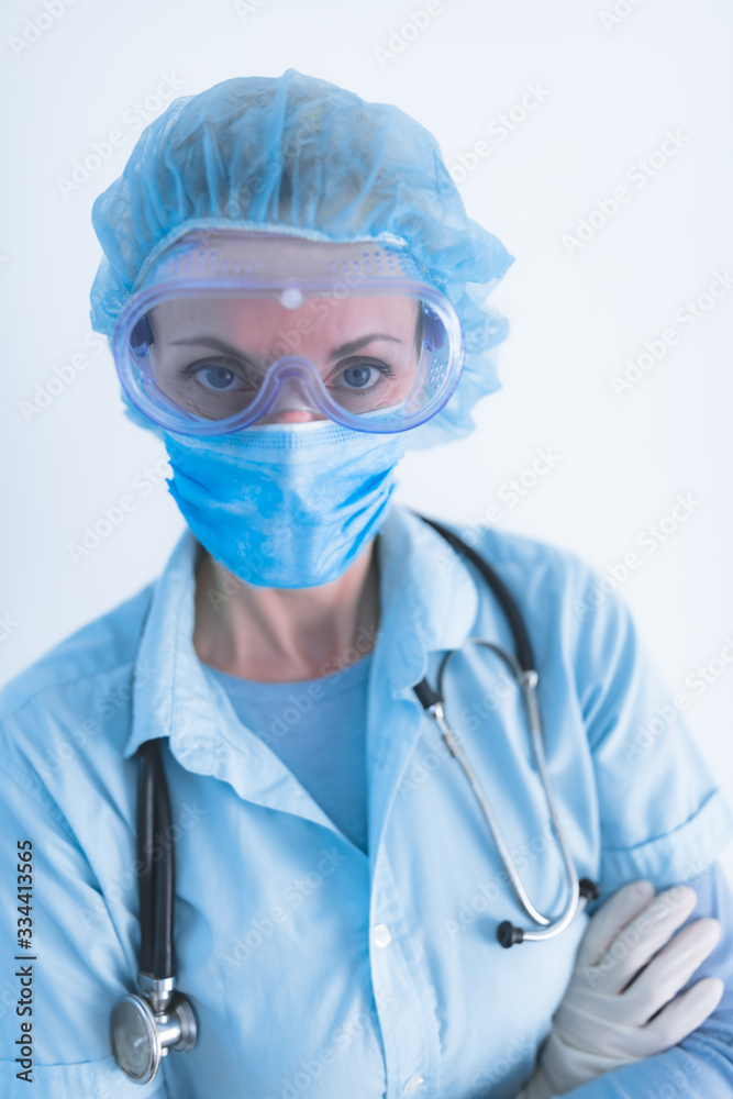 Medical doctor, nurse, surgeon, psychologist working with protective mask, glasses and gloves helping people in the days of panic, pandemic.