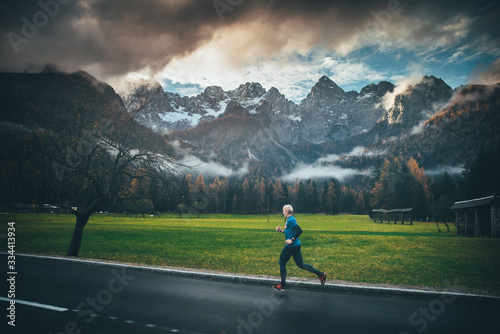 Morning run in autumn mountains landscape. Alps in background. Italy. © kovop58