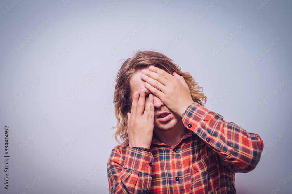 Man closes eyes with her hands Man closes eyes with her hands